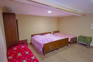 a room with two beds and two chairs in it at Holiday Home Ekaterine in Telavi