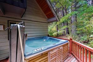 a hot tub on the deck of a cabin at Ridge View Retreat - 3 Bed 2 Bath Vacation home in Lake Wenatchee in Leavenworth