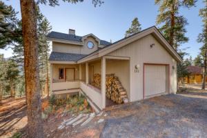 a house with a garage with a bunch of logs at 161 Emmett Lode in Breckenridge