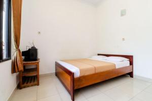 Rúm í herbergi á Hotel Wismancala Kaliurang