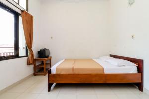 Rúm í herbergi á Hotel Wismancala Kaliurang