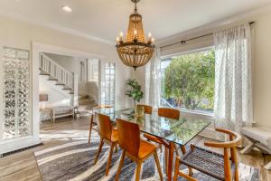 a dining room with a glass table and chairs and a chandelier at Fremont Oasis in Seattle