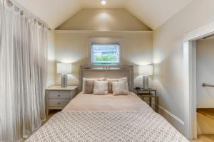 a bedroom with a bed with two lamps and a window at Fremont Oasis in Seattle