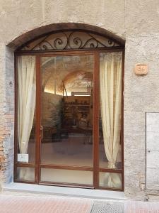 a window of a building with curtains in it at Il Nido Di Anna in San Gimignano