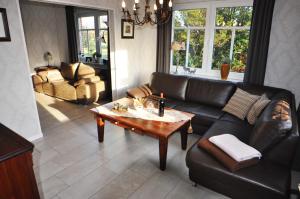 a living room with a couch and a table at Ferienhaus Adamla, 65319 in Moormerland