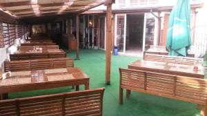 a row of wooden tables and benches in a restaurant at Casa Blanca in Sofia