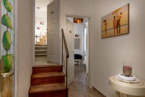 a hallway with stairs leading to a home with a painting at Residenza Conte di Cavour & Rooftop in Florence