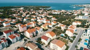 an aerial view of a city with houses and the ocean at Pink House Apartments in Novalja +4 photos