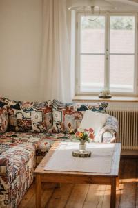 a living room with a couch and a coffee table at Ferienwohnung im Mühlviertler Panorama Vierseithof in Lembach im Mühlkreis