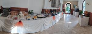 a long table in a room with items on it at Hotel Giulio Cesare in Rapallo