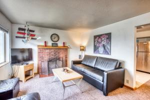 a living room with a leather couch and a fireplace at Beaches Inn | Buccaneer Bay Bungalow in Cannon Beach