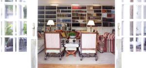 a living room with a table and chairs and a library at Suites de Franchy in La Orotava