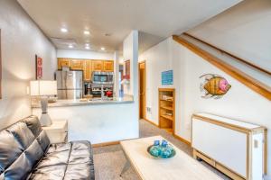 a living room with a couch and a table at Beaches Inn | Pacific Surf Townhouse in Cannon Beach