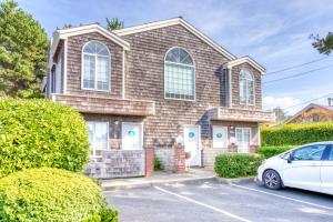 a house with a car parked in a parking lot at Beaches Inn | Puffins Place Cabana in Cannon Beach