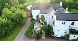 an aerial view of a white house with a yard at Broome Farm in Ross on Wye