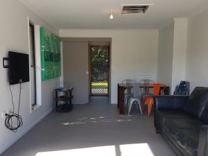 a living room with a couch and a table at Coora 13 in Rainbow Beach