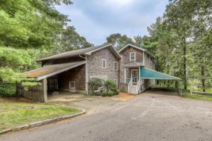 an old brick house with a garage and a driveway at The CAVU Mansion on Bellevue in Oklahoma Heights