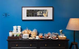 a table with food on top of a blue wall at Easy Room in Nizhny Novgorod