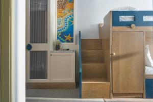 a room with a door and a stair case at Sofiana My Khe Hotel & Spa- Rooftop Pool Bar in Danang