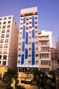 a tall building with a sign on the side of it at Sofiana My Khe Hotel & Spa- Rooftop Pool Bar in Danang