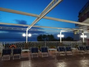 a group of chairs on a patio at night at Hotel Dania in Sorrento
