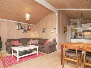 uma sala de estar com um sofá e uma mesa em 6 person holiday home in Frederikshavn em Frederikshavn