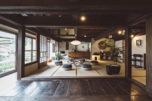 a large living room with a table and chairs at NIPPONIA Kosuge Village in Kosuge