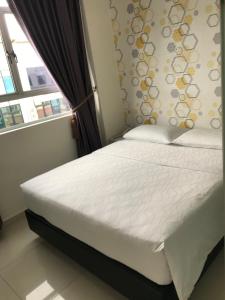 a bed in a bedroom with a window at GOODY HOTEL in Johor Bahru