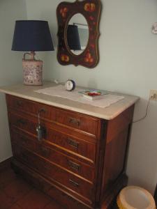 a dresser with a mirror and a lamp on it at Il Sorriso Dei Monti in Orvinio