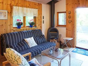 a living room with a blue couch and a fireplace at 4 person holiday home in EKER in Ekerö