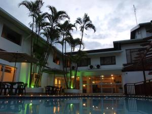 a hotel with a swimming pool in front of a building at Premier Splendid Inn Pinetown in Pinetown