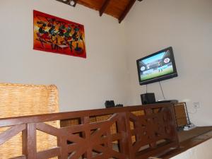 a living room with a tv on the wall at Blue Bay Cove, Penthouse 4 in Watamu