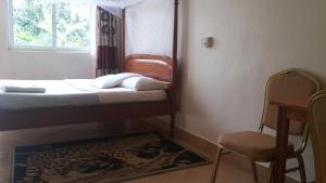Postel nebo postele na pokoji v ubytování RoseVilla Hotel