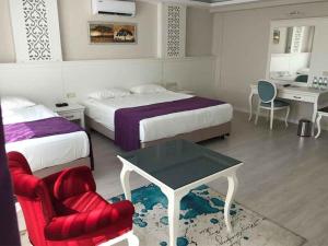 Ein Bett oder Betten in einem Zimmer der Unterkunft Prime Boutique Hotel