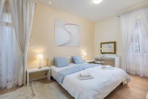 een slaapkamer met een groot bed en 2 ramen bij Apartment Rona Opatija Superior in Opatija