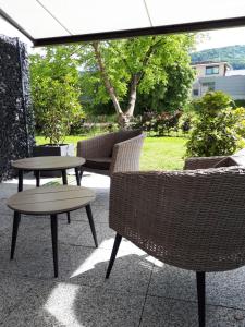 a patio with two tables and chairs and an umbrella at Bad Säckingen - Sie werden sich hier wohl fühlen in Bad Säckingen