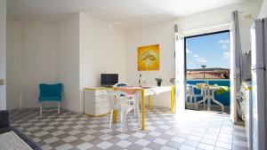 een kamer met een bureau met een computer en een balkon bij Grecale comfort House in Santa Teresa Gallura