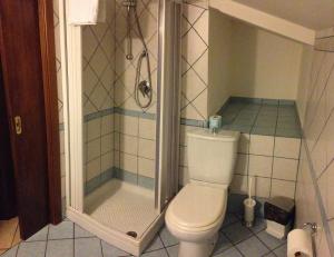 a bathroom with a shower and a toilet at B&B Miramare in Giardini Naxos