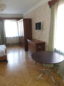 a living room with a table and a dresser at Don-Antonio in Krasnodar