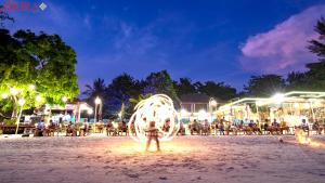 a person standing on a beach at night at AKIRA Lipe Resort in Ko Lipe +37 photos