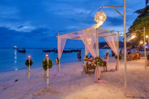 a wedding ceremony on the beach at night at AKIRA Lipe Resort in Ko Lipe