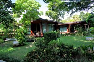 a house in the middle of a yard at AKIRA Lipe Resort in Ko Lipe
