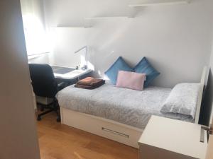 1 dormitorio con 1 cama, escritorio y ordenador en Piso semicentrico con vistas a la bahía de Algeciras en Algeciras