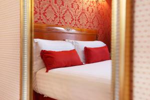 a bed with a white bedspread and pillows at Hotel De Seine in Paris