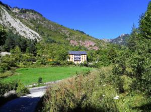 a house on the side of a hill next to a road at Caserón Baruca in Bielsa