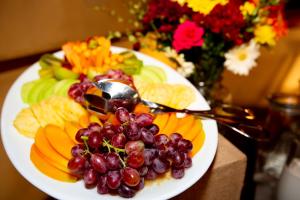 une plaque de raisins et de fruits sur une table dans l'établissement Island Safari Lodge, à Maun