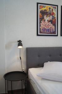 een slaapkamer met een bed, een tafel en een poster bij Apartments Mario with private parking in Makarska