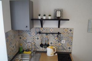 a kitchen with a sink and a counter top at Apartments Mario with private parking in Makarska