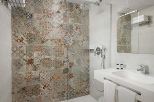 a bathroom with a toilet and a sink and a shower at Hotel Boutique Calas de Alicante in Alicante