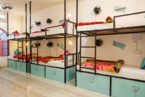 a room with four bunk beds in it at Moustache Khajuraho in Khajurāho